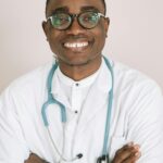 Professional African doctor smiling confidently with a stethoscope.